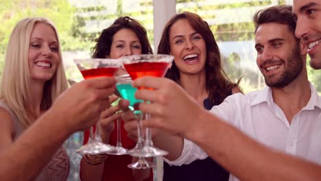 group of friends toasting with cocktail