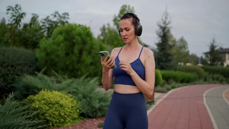 woman on a run using smartphone and headphones