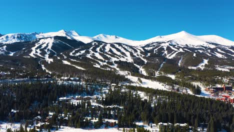 mountains covered in white snow with ski slope trails