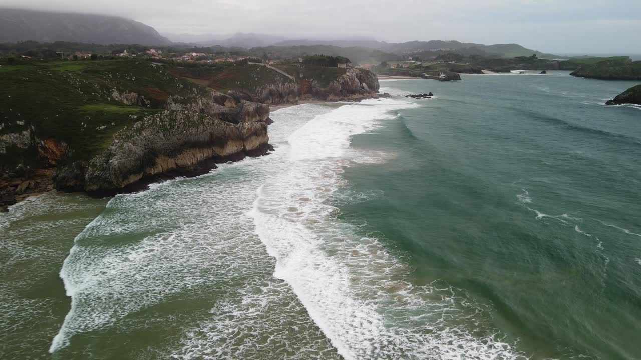 Aerial of Canabrian shore coastline cliff with waves crashing on rocks