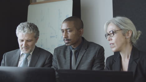 diverse coworkers group meeting and talking at workplace