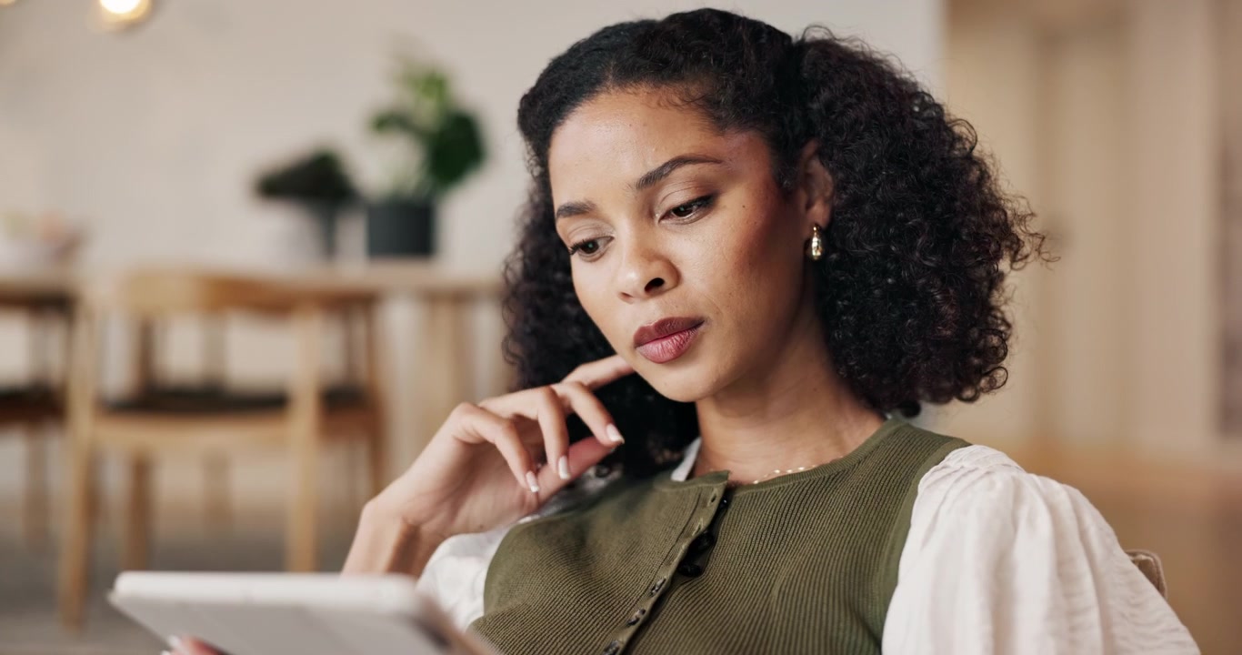 Focused Woman Using Digital Tablet in Modern Home Interior
