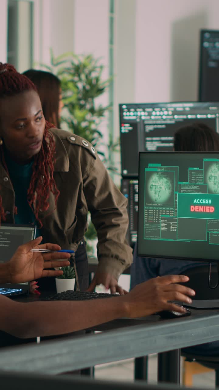 Vertical video: Team of coders writing data and encountering system crash