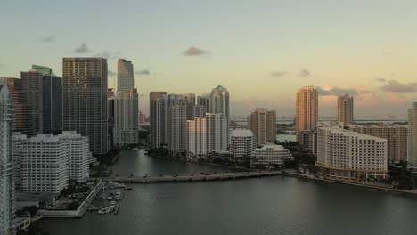 Cinematic-Pan-Aerial-Shot-of-Brickell-Key-In-Miami-Florida-at-Sunset-During-Golden-Hour