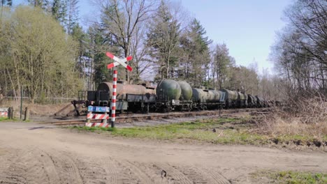 train with tank cars passing through a rural area