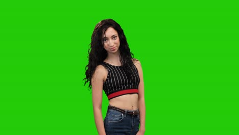 slim girl with long curly hair turns on green screen