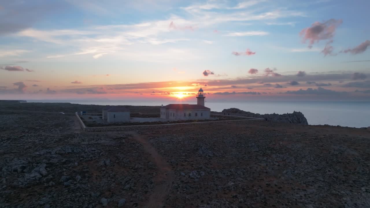 Sunset Menorca island coastline Punta Nati Lighthouse Spain, aerial drone