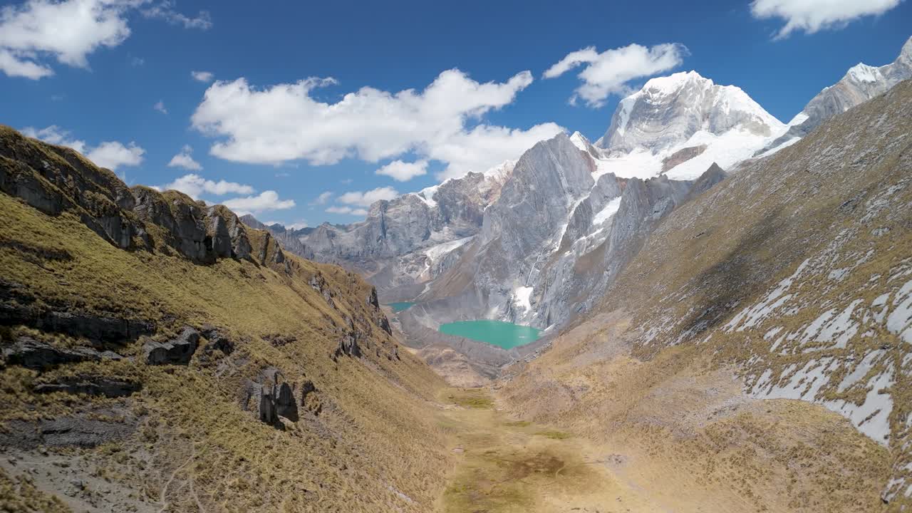 Flying through a dramatic valley on the scenic Huayhuash trek, capturing glacial lakes, steep peaks, and wild Peruvian Andes landscapes
