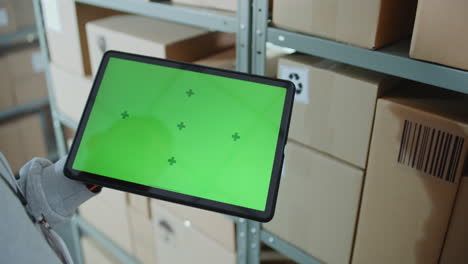 warehouse worker using tablet for inventory