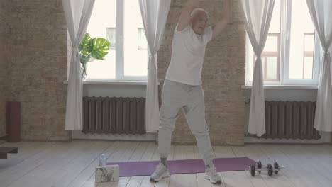 old male exercising and stretching at home