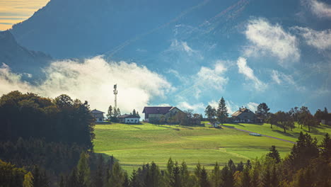 the movement of the morning clouds over houses in the austrian alps