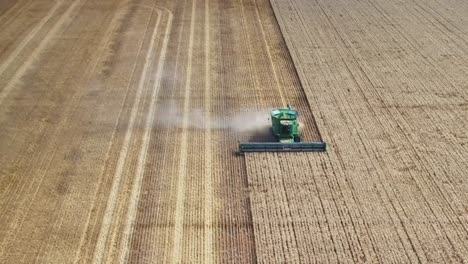 Overhead-view-of-a-harvester-working-a-field-of-wheat-near-Yarrawonga,-Victoria,-Australia