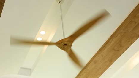 a ceiling fan spins with increasing speed