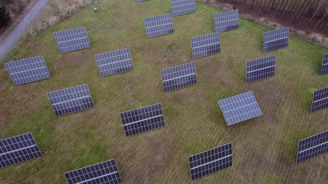 View from a drone on rotating solar panels placed on the grass in autumn in the Czech Republic