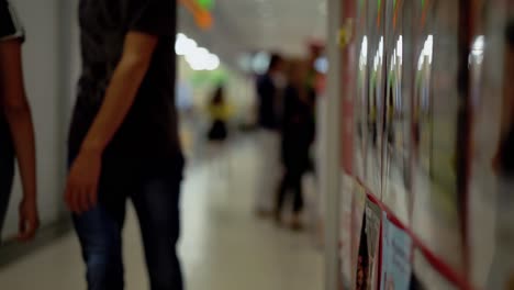 people walk along the supermarket corridor the reflections 1