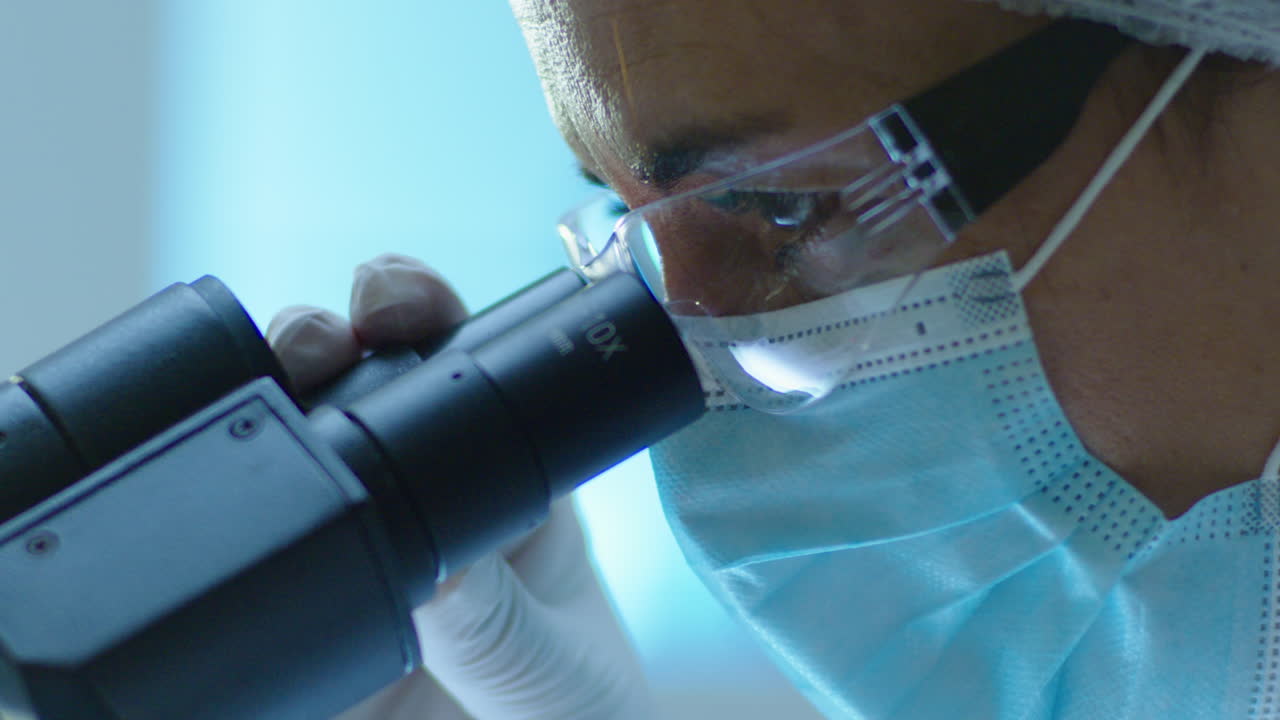 Scientist using a microscope in a laboratory setting