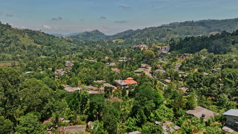 pussellawa sri lanka aerial v4 low level drone flyover village town along a5 road capturing hillside tea plantations and mountainous landscape on a sunny day - shot with mavic 3 cine - april 2023