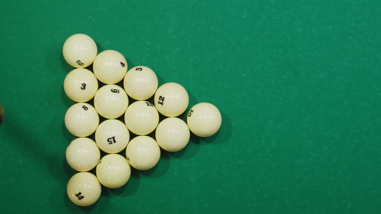 Beginning of game white pool balls top view on green billiards table for start to play. Russian biliard game, Russian pyramid. Billiard balls with numbers on a pool table. Billiards team sport.High quality 4k footage