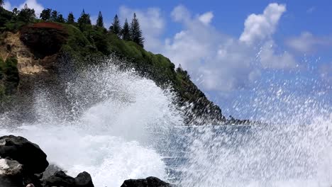 waves crush on the rocks on the pacific island pitcairn shore