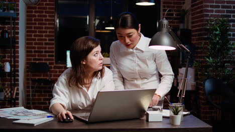 Coworkers-using-laptop-to-finalize-deal-with-business-partners