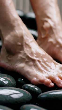 woman's feet on hot stones