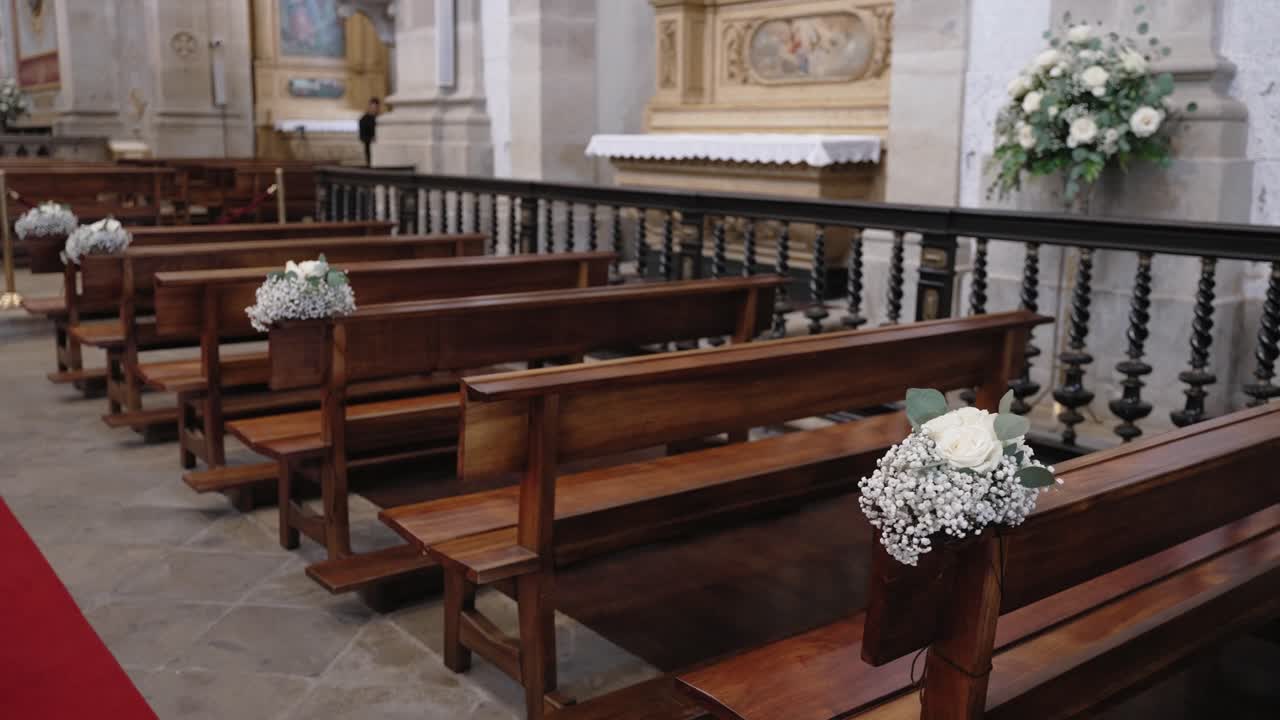 Church benches with wedding flower decor and red carpet inside Bom Jesus Church