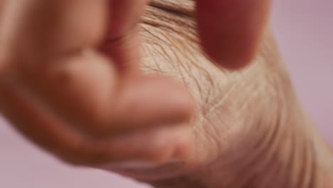 Applying-petroleum-jelly-on-dry-feet