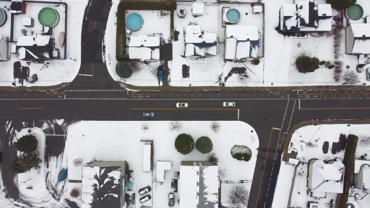 Aerial: residential homes with snow during the day in Brossard, Quebec, Canada, bird's eye view drone shot