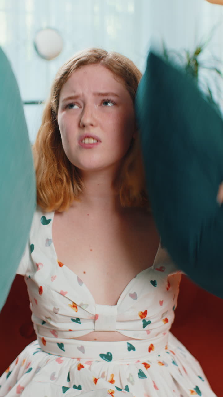 Repair work at neighbours concept irritated woman at home cover ears with pillows annoyed by noise