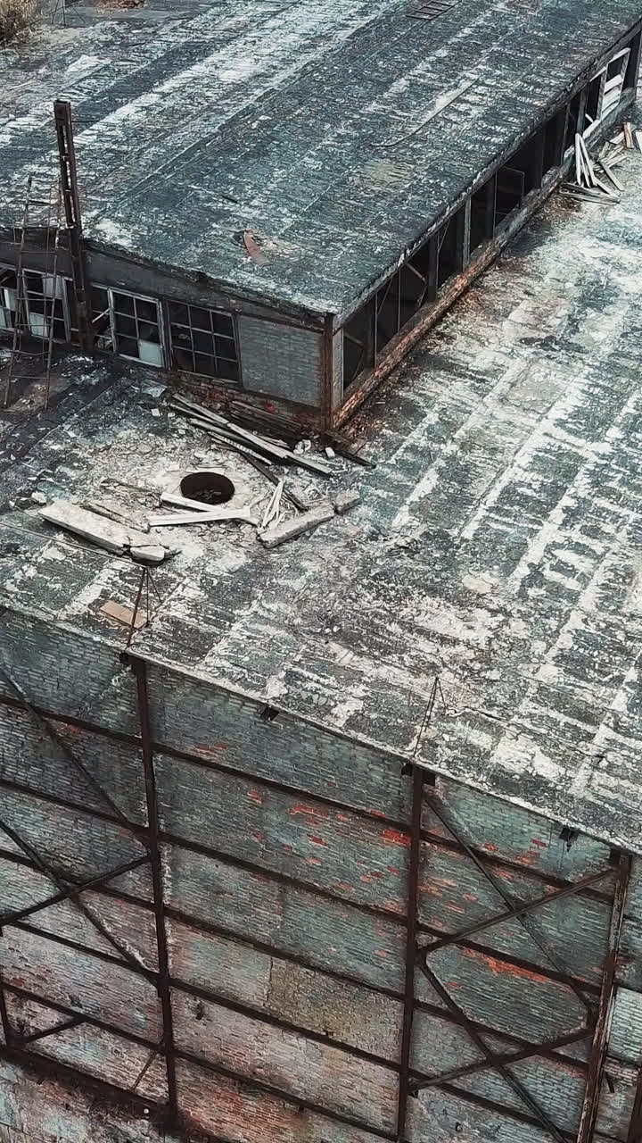 Abandoned ruined industrial factory building, ruins and demolition concept. Aerial view. Vertical video