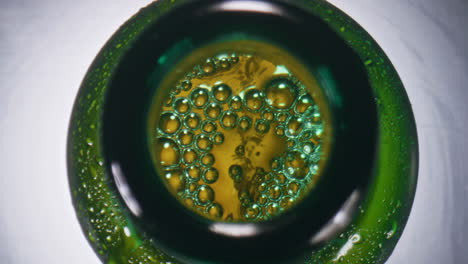 closeup effervescing beer vessel. alcoholic liquor bubbling inside glass bottle