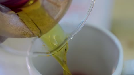 macro-image-of-coffee-being-poured-in-a-white-cup