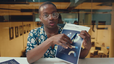 young businesswoman explaining financial chart during web conference