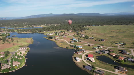 aerial view of hot air balloon flying above lake and landscape of pagosa springs colorado usa