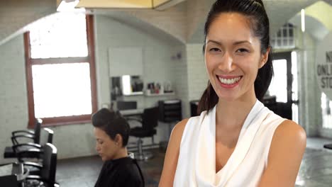 female hairstylist standing in salon