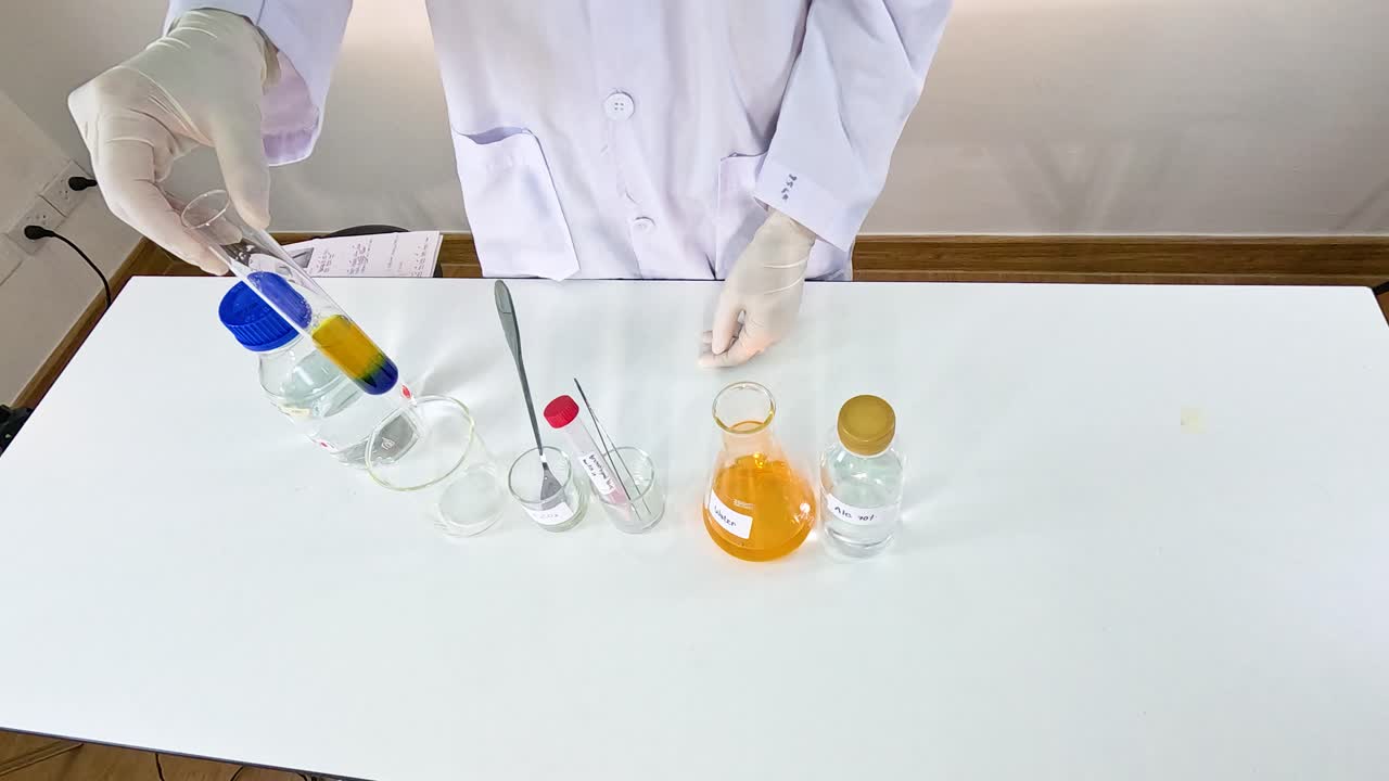 Scientist conducts a bromothymol blue experiment, observing color changes in a lab setting with controlled lighting