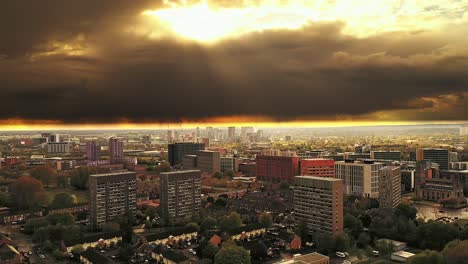 Aerial-drone-rising-over-Manchester-city-skyline-housing-estate-apartments,-England