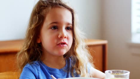 girl having breakfast at home