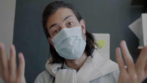 man wearing mask during video call