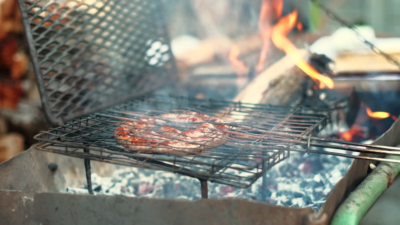 Grilling traditional South African boerewors (sausage) on hot coals of wood fire