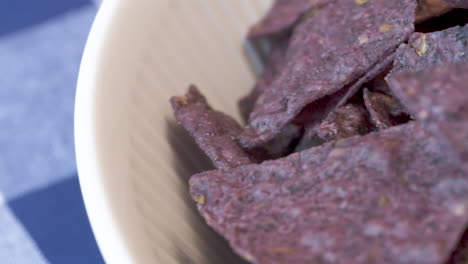 Close-up-slide-across-an-appetizing-bowl-of-crunchy-nacho-chips