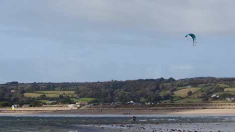 long-shot-of-mount-Bay-beach-at-low-tide-with-kite-surfer-in-the-air