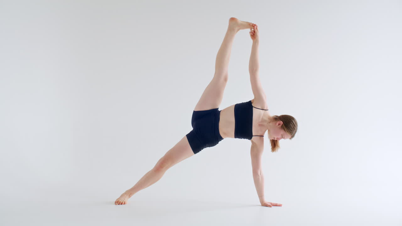 Athletic Girl Performing Yoga Poses in Studio with White Background