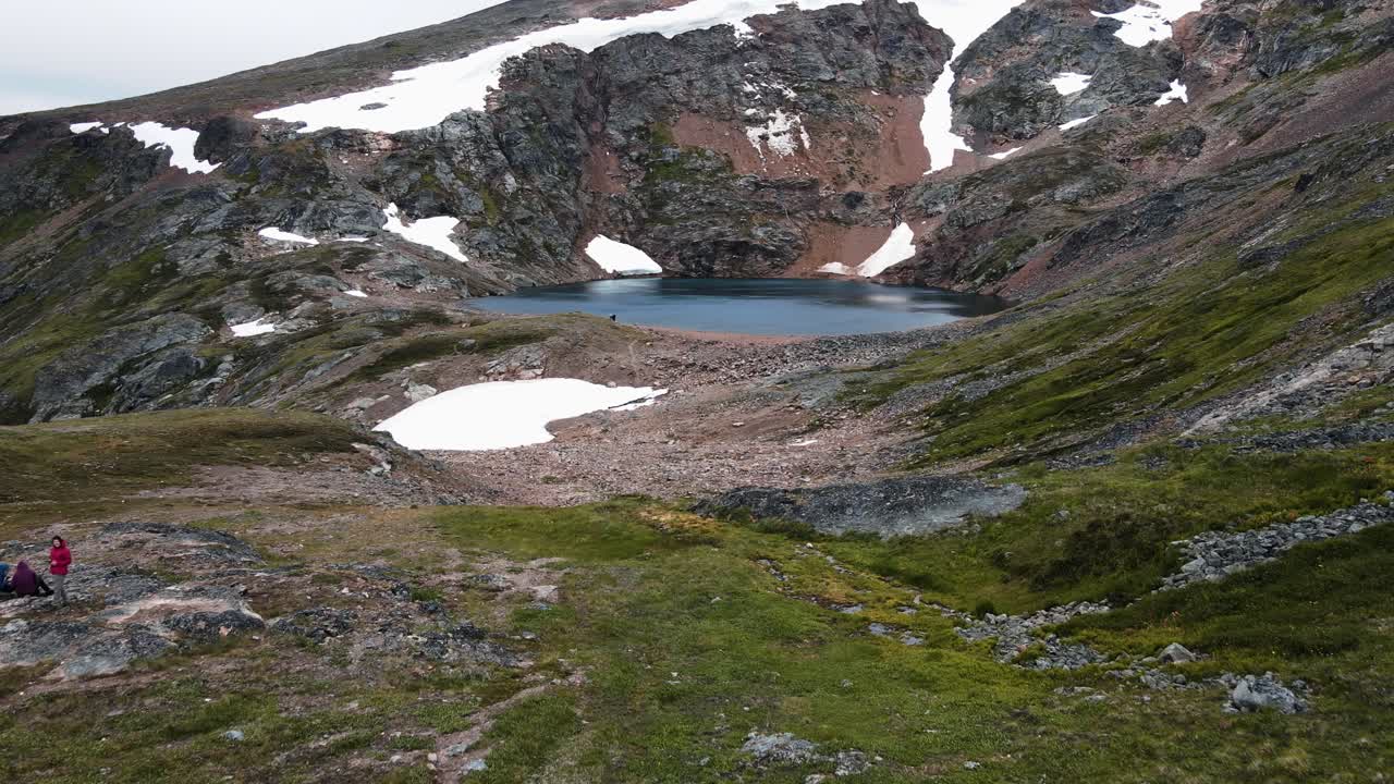 excursionistas sentados al borde del hermoso lago del cráter cerca de la ciudad de smithers en columbia británica, canadá