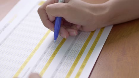 a student diligently takes notes during a lecture emphasizing the importance of written learning