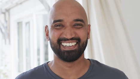 Portrait-of-happy-biracial-man-at-home,-slow-motion