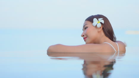 dreamy woman in swimming pool, soft focus blurred background portrait