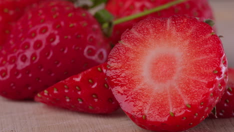 cut up strawberry infront of other strawberries