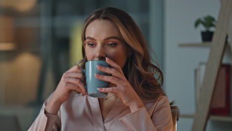 happy businesswoman enjoying cup of coffee in office. closeup relaxed woman
