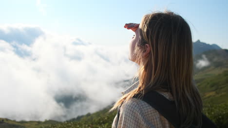 woman hiking in mountains with clouds